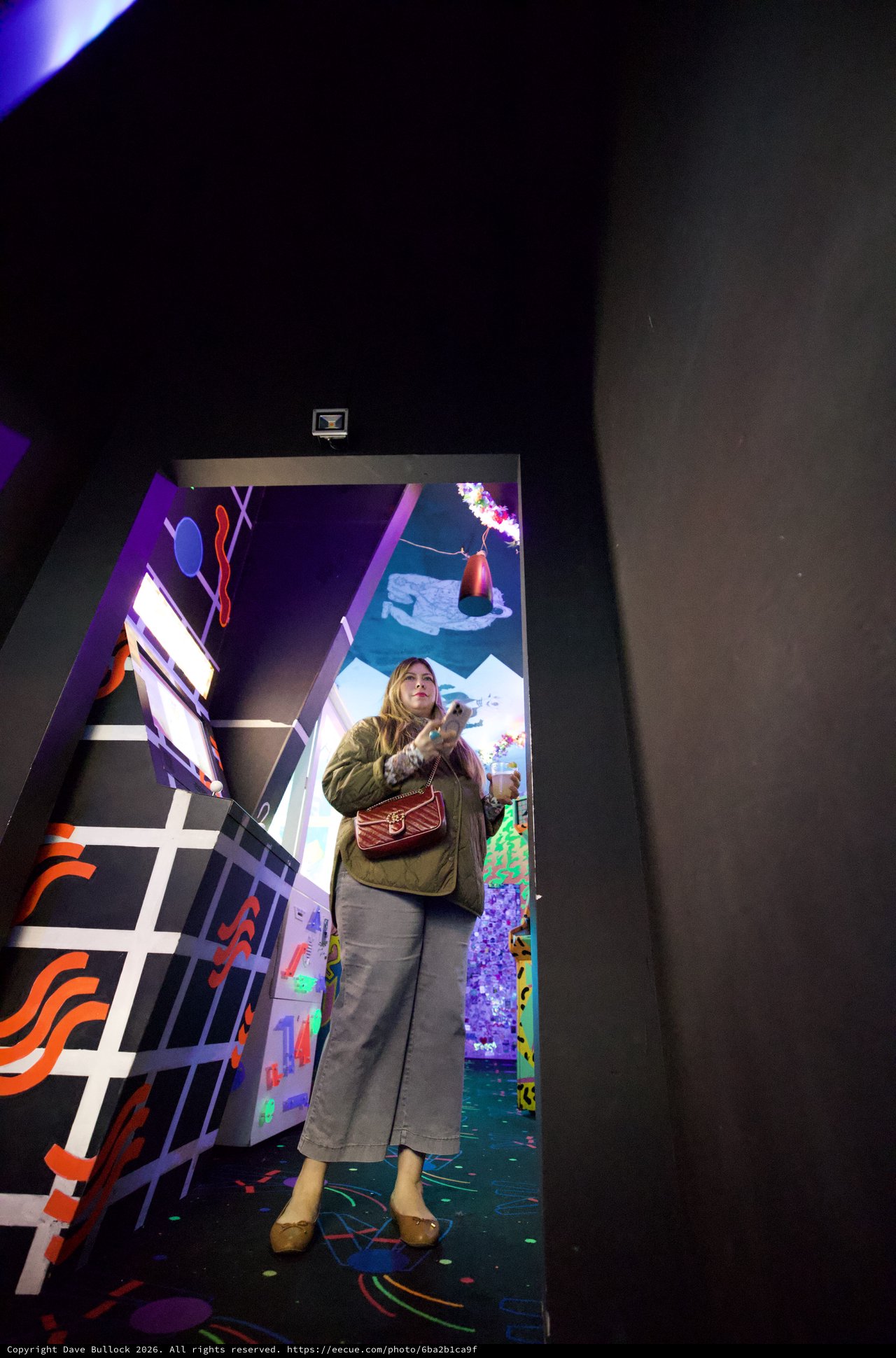 Woman in Colorful Installation Art Space with Mirror