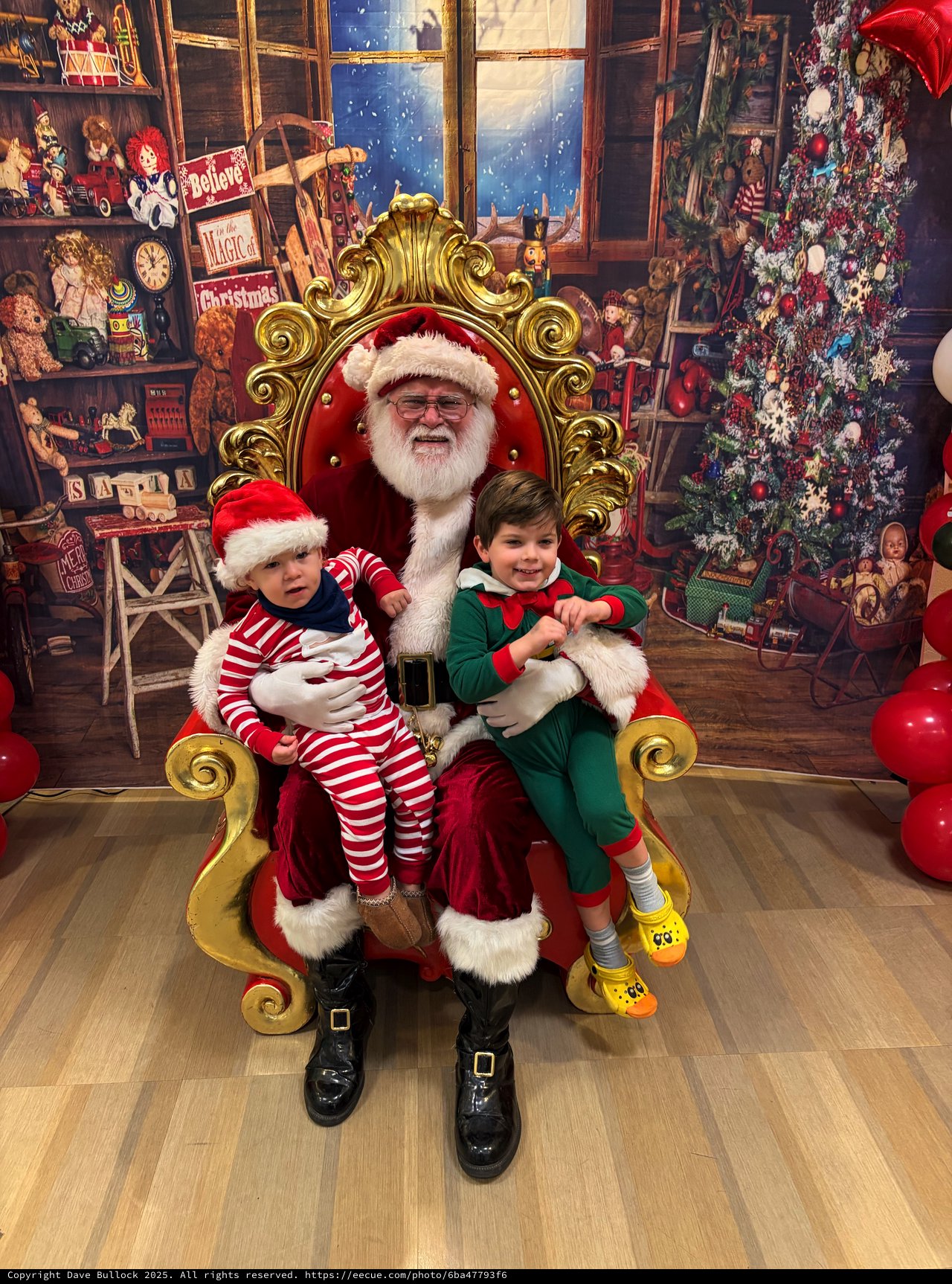 Two Children Visit Santa in His Christmas Workshop