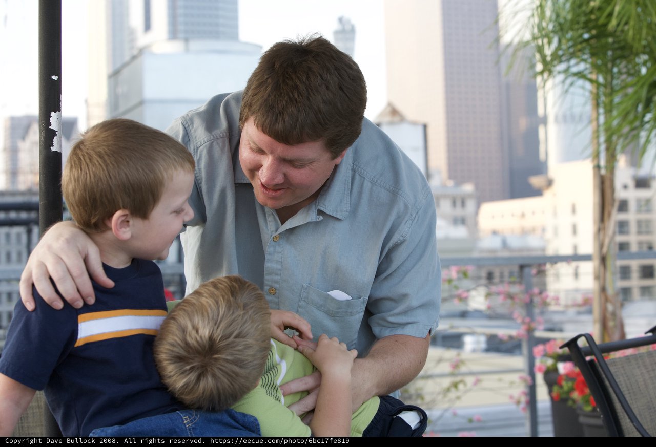 Father Shares a Tender Moment with Two Sons