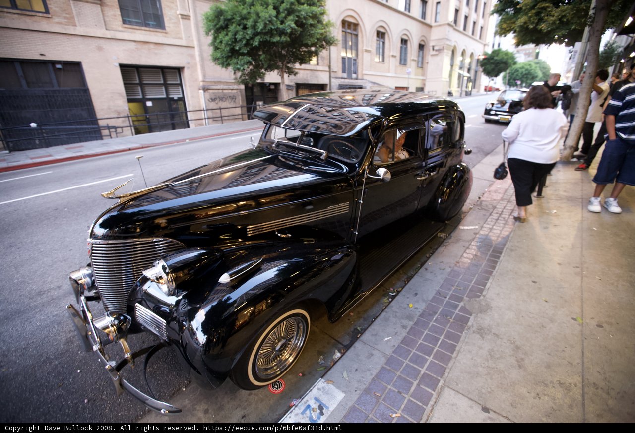 Black Convertible Hot Rod Parked on a Sidewalk