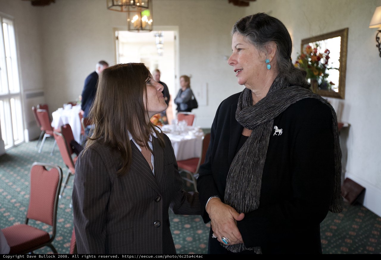 Two Women in Heartfelt Conversation at Memorial Gathering