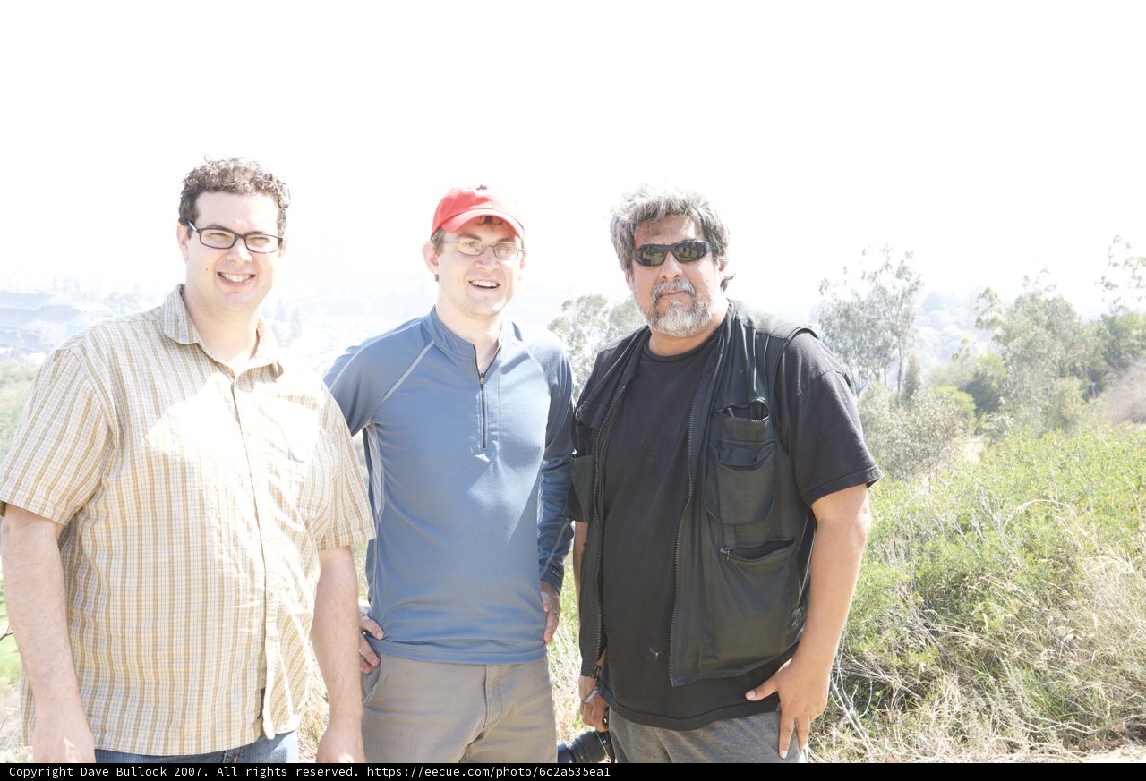 Three Men Enjoying a Picnic Outdoors