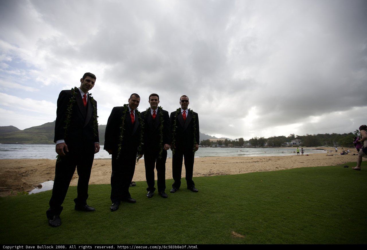 Four Men in Suits Relaxing by the Shore
