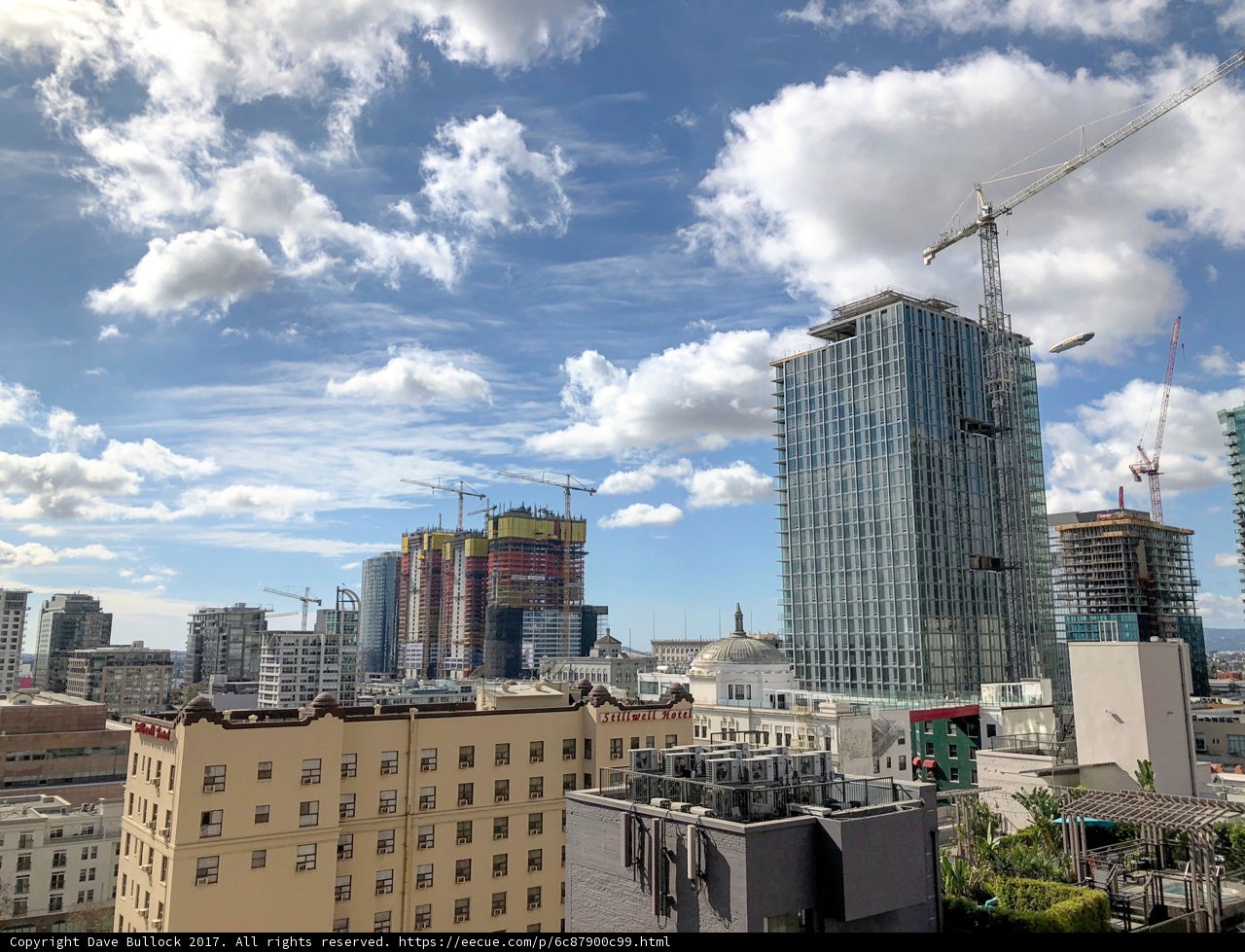 Urban Landscape: A city view with five construction cranes
