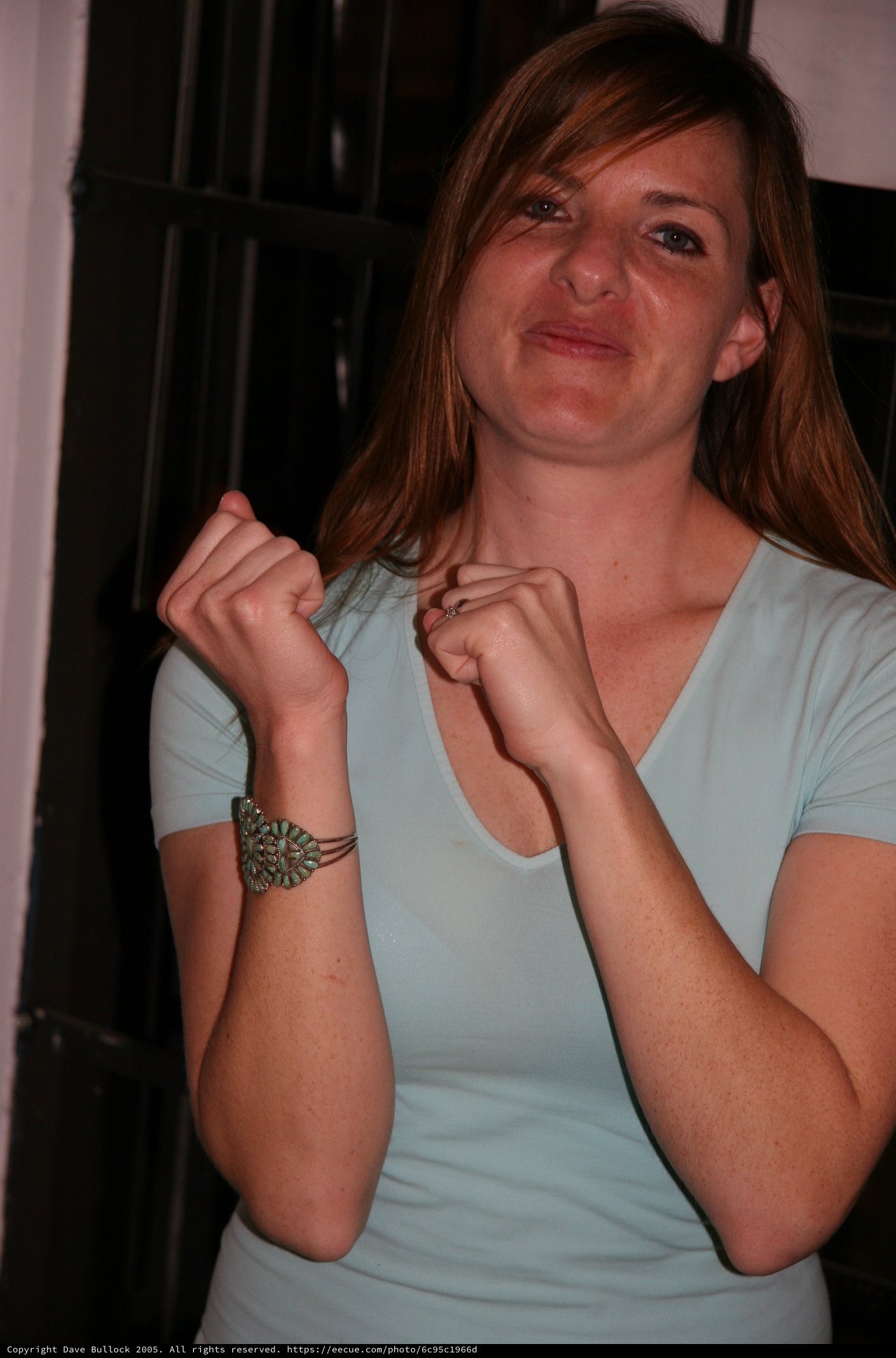 Playful Woman with Turquoise Bracelet Makes Funny Face