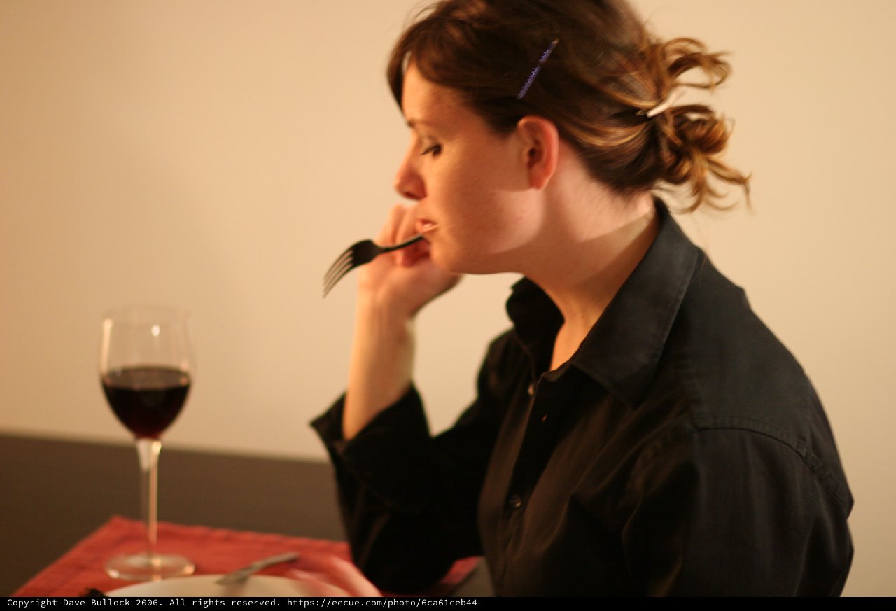 Contemplative Woman Dining Alone with Red Wine