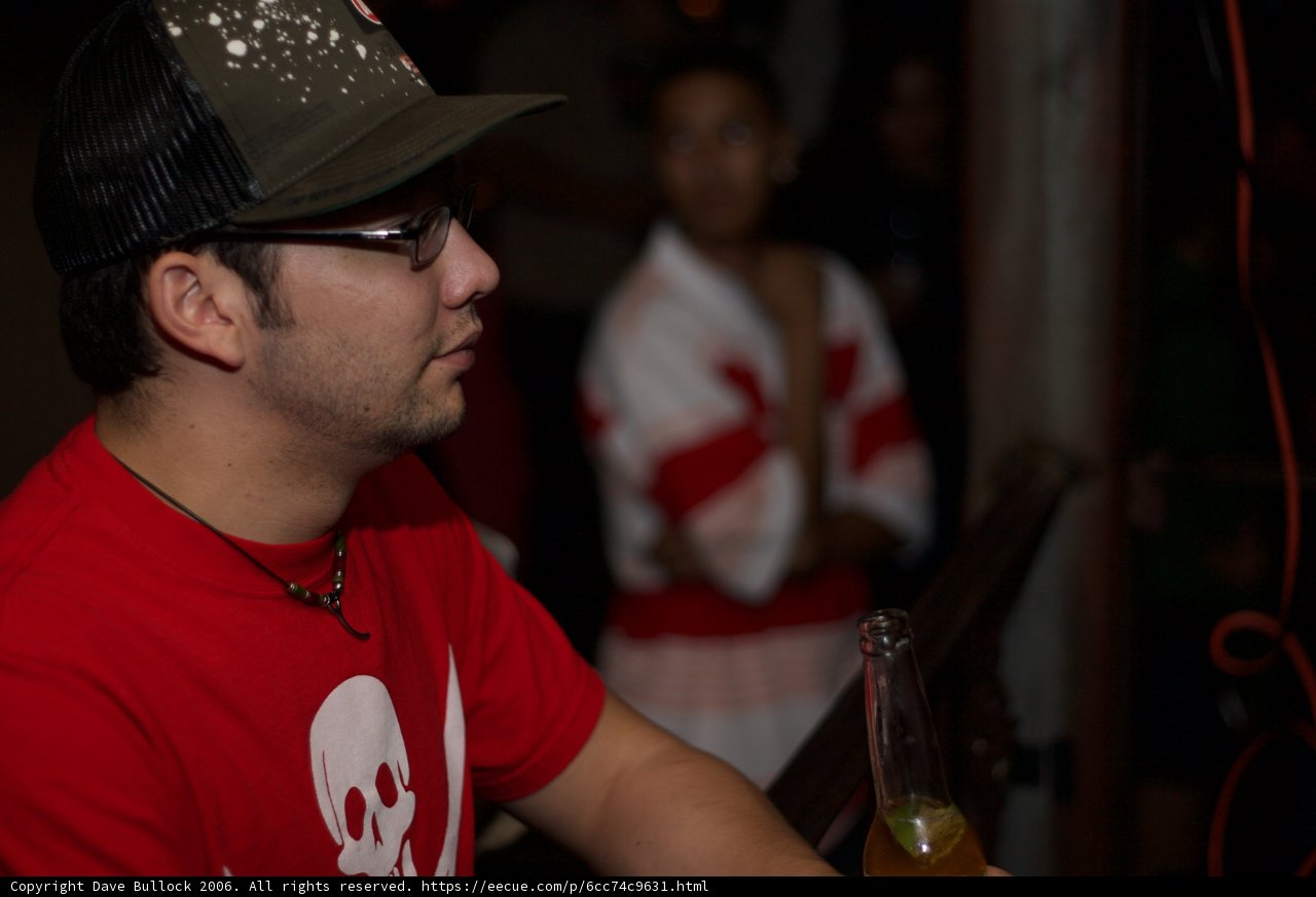 Red Shirted Man Enjoys Beverage at Pub