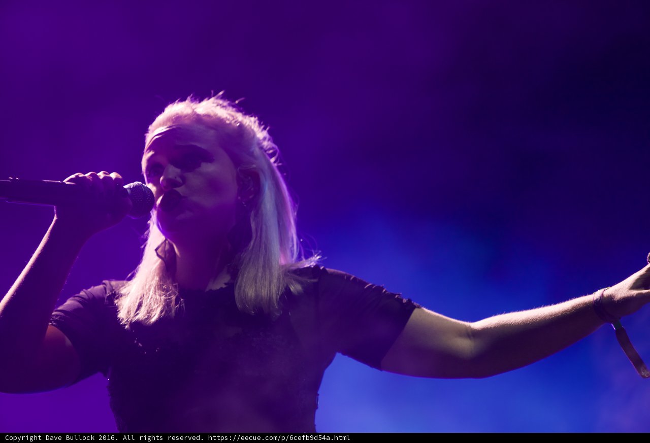 Rocking the Stage: Blonde-haired Singer Performs Solo