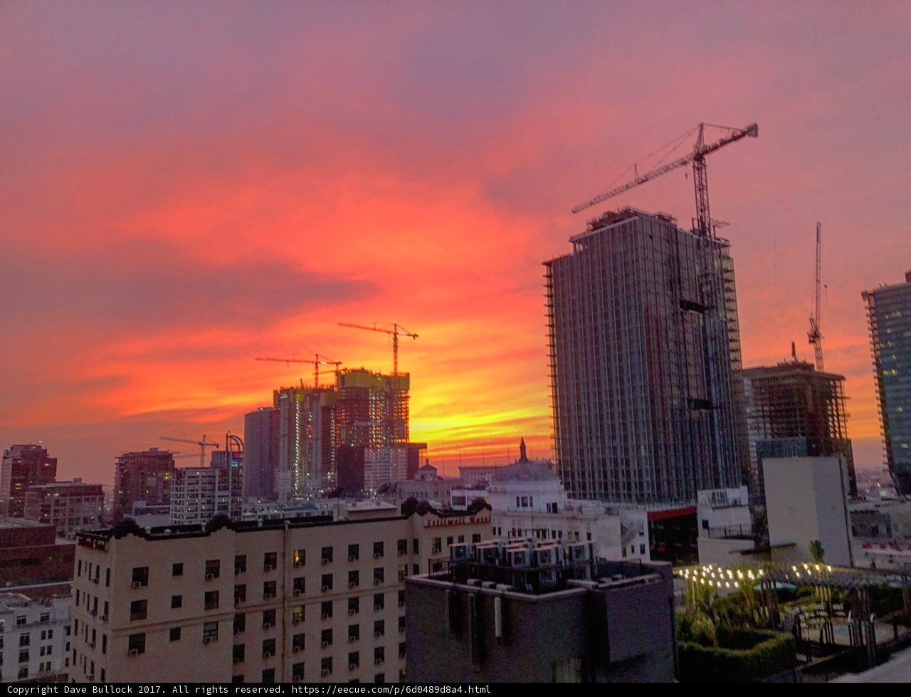 Sunset Cityscape with Construction Cranes