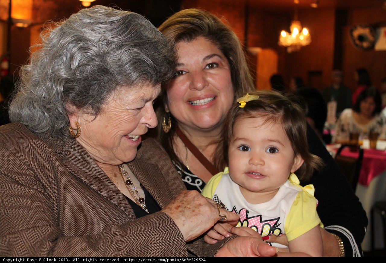 Family of Three Smiling at Restaurant