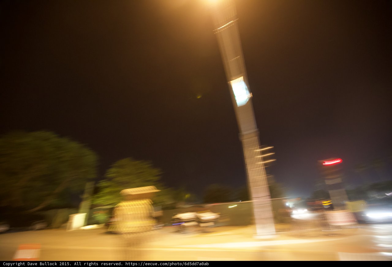 Blurry Street Light Illuminates Night Road