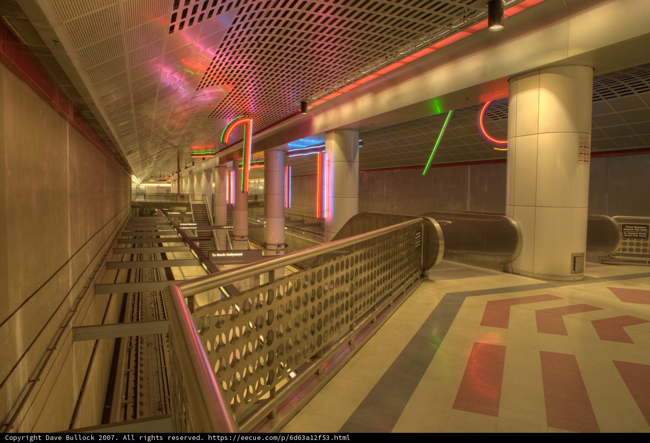 Neon-Framed Escalator Leading to the Terminal