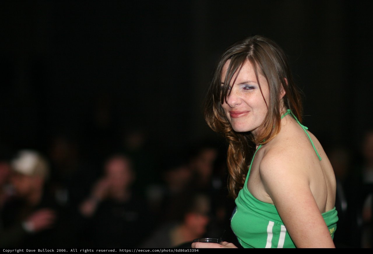 Woman in Green Halter Top at Evening Event
