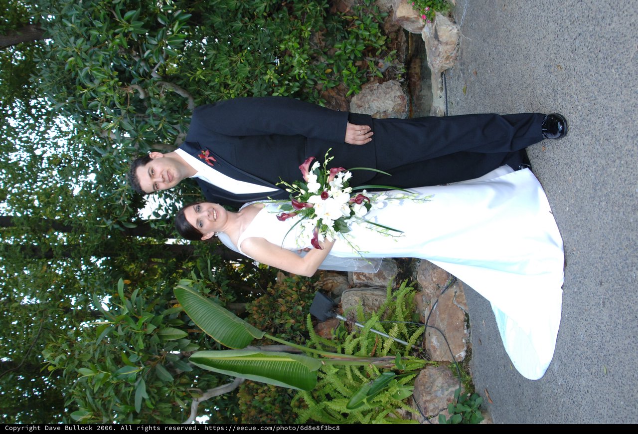 Bride and Groom Pose in Lush Garden Setting