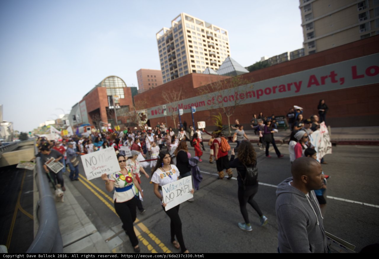Pre-Coachella Protesters march down the street holding signs