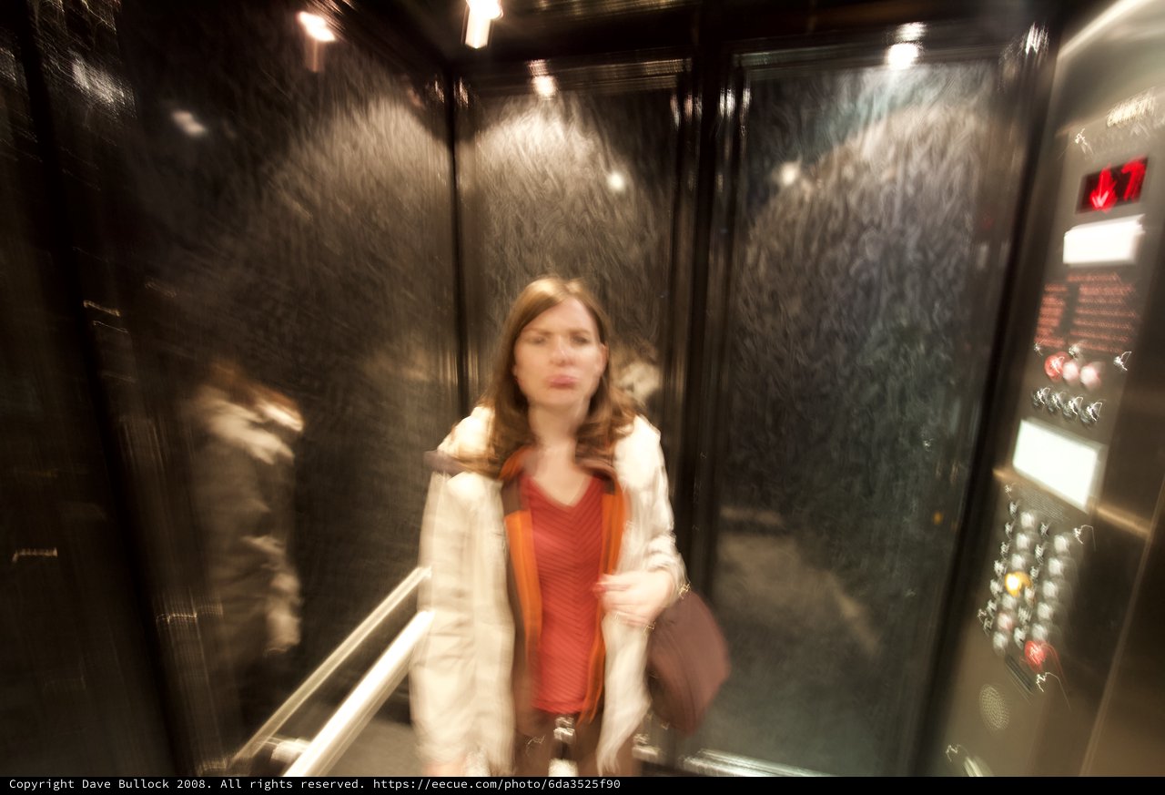 Motion Blur Portrait of Woman in Dark Elevator