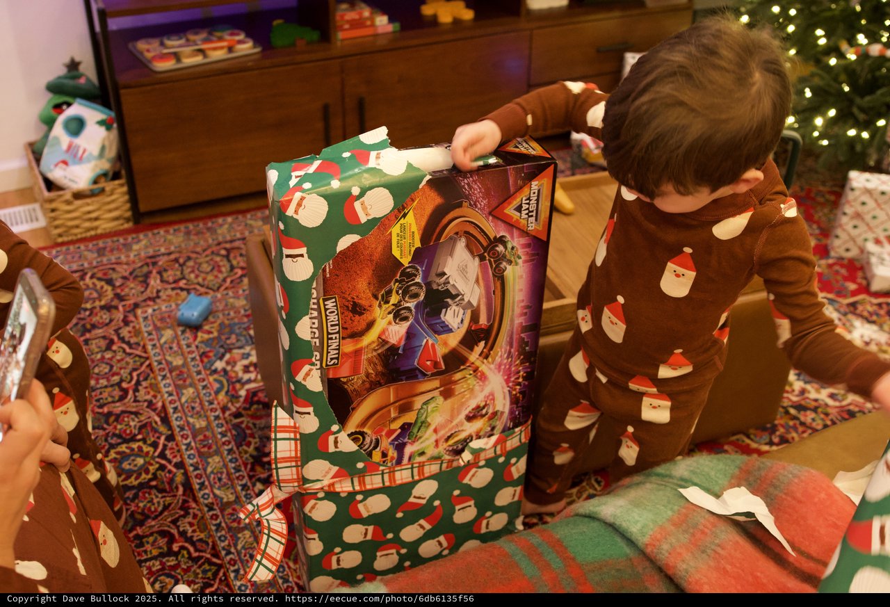 Child Unwrapping Wolverines Toy on Christmas Morning