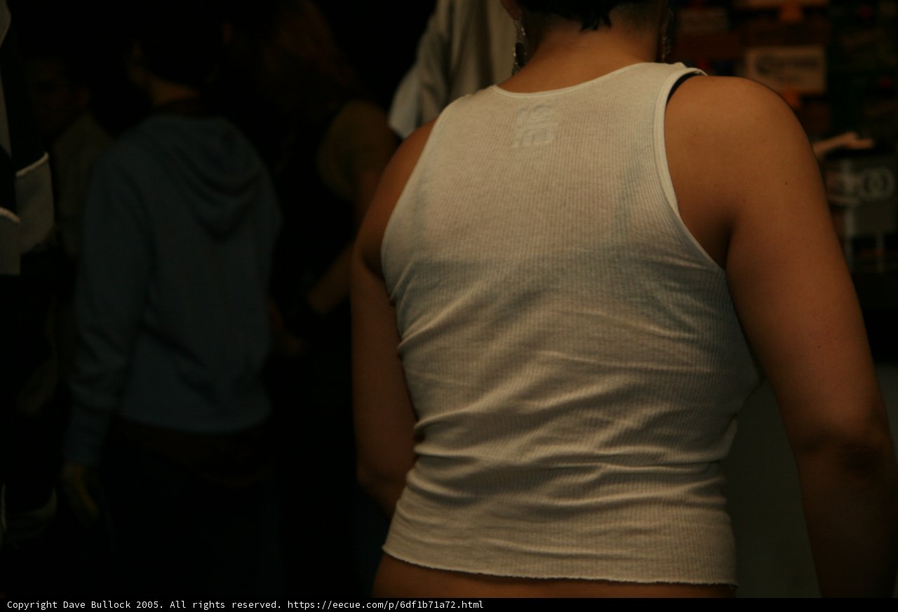Back of a woman in white tank top