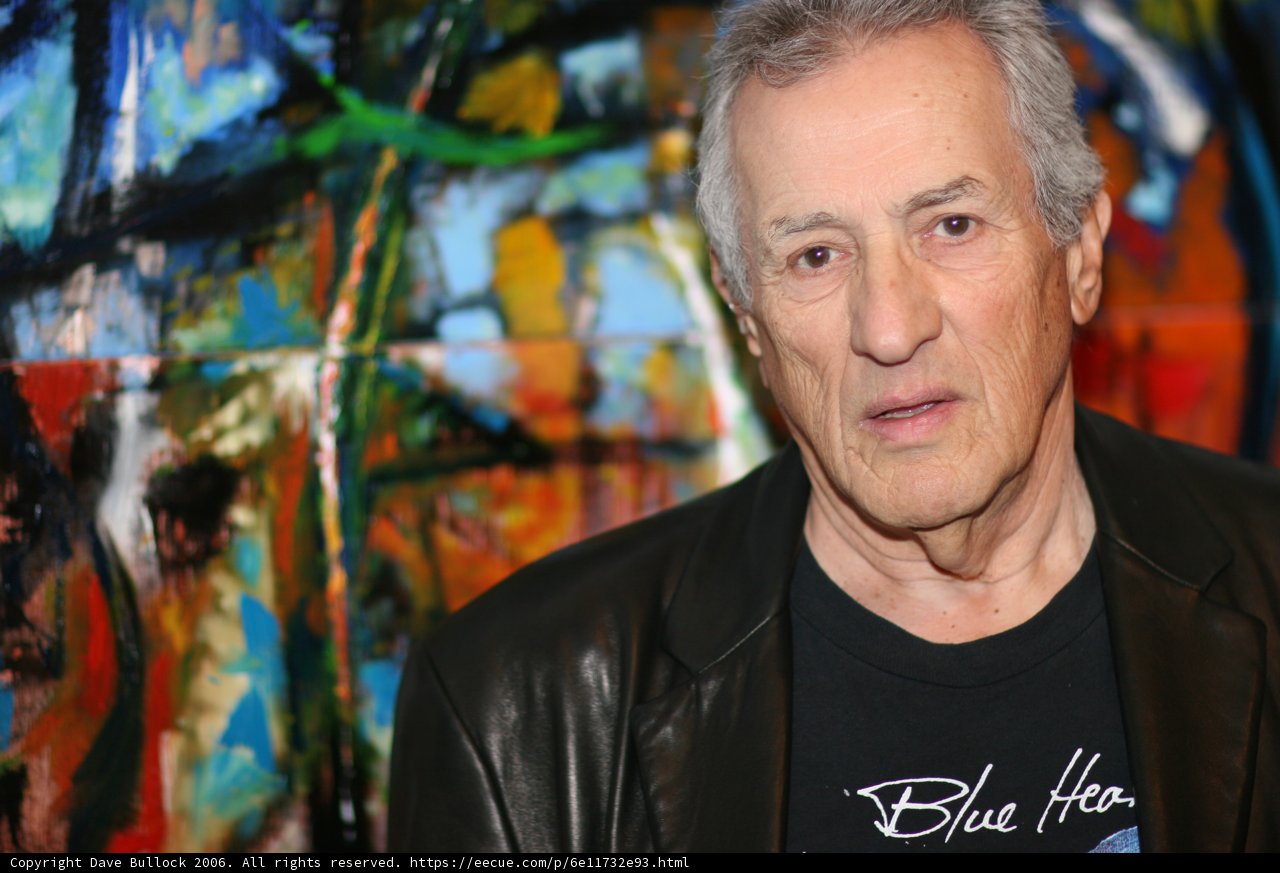 Older Man in Classic Black Coat at Art Walk
