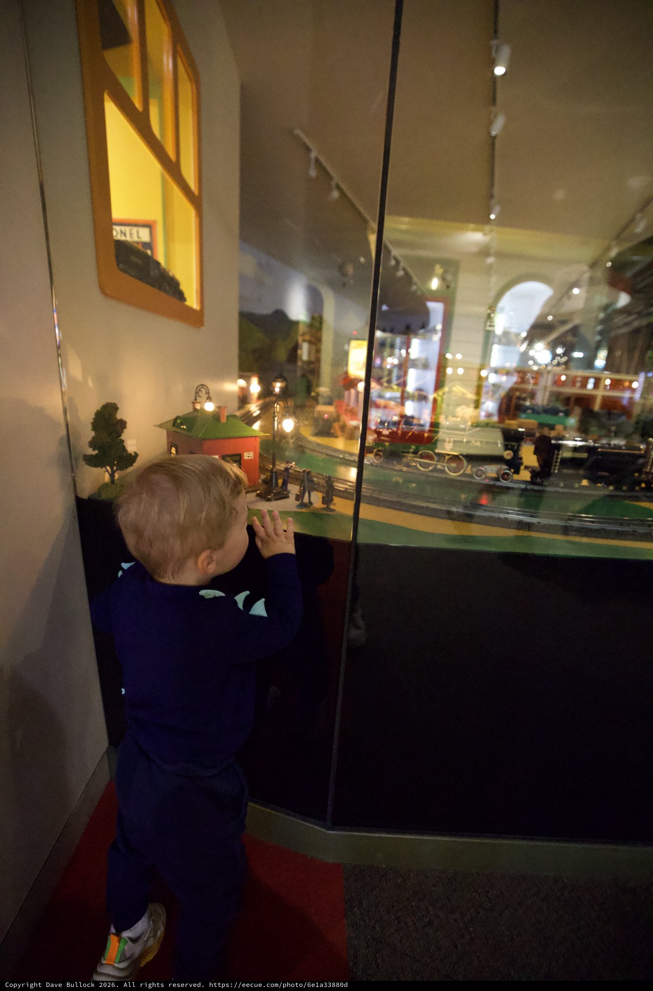 Young Child Mesmerized by Vintage Train Display