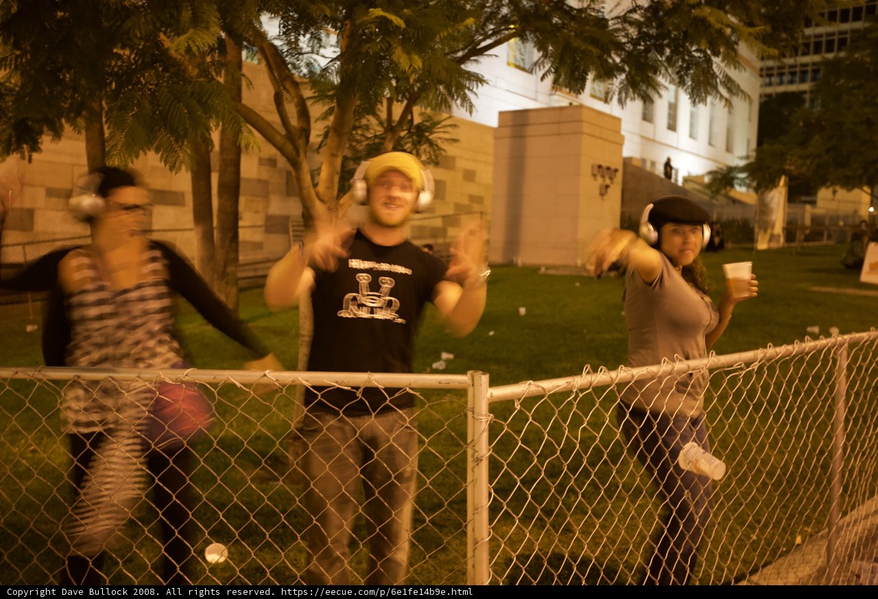 Group of Eight Standing in Front of a Fence