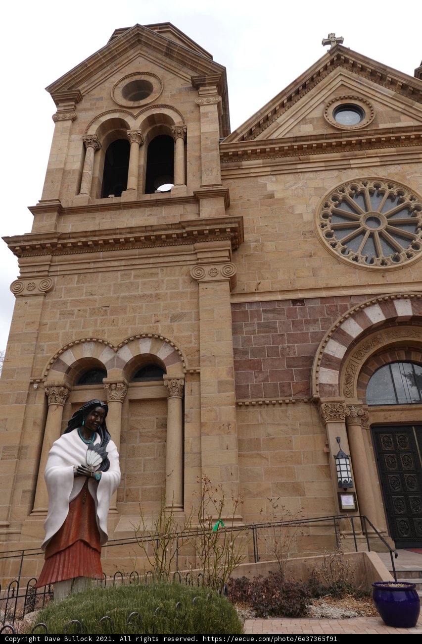 Statue of a Woman Standing in Front of a Church