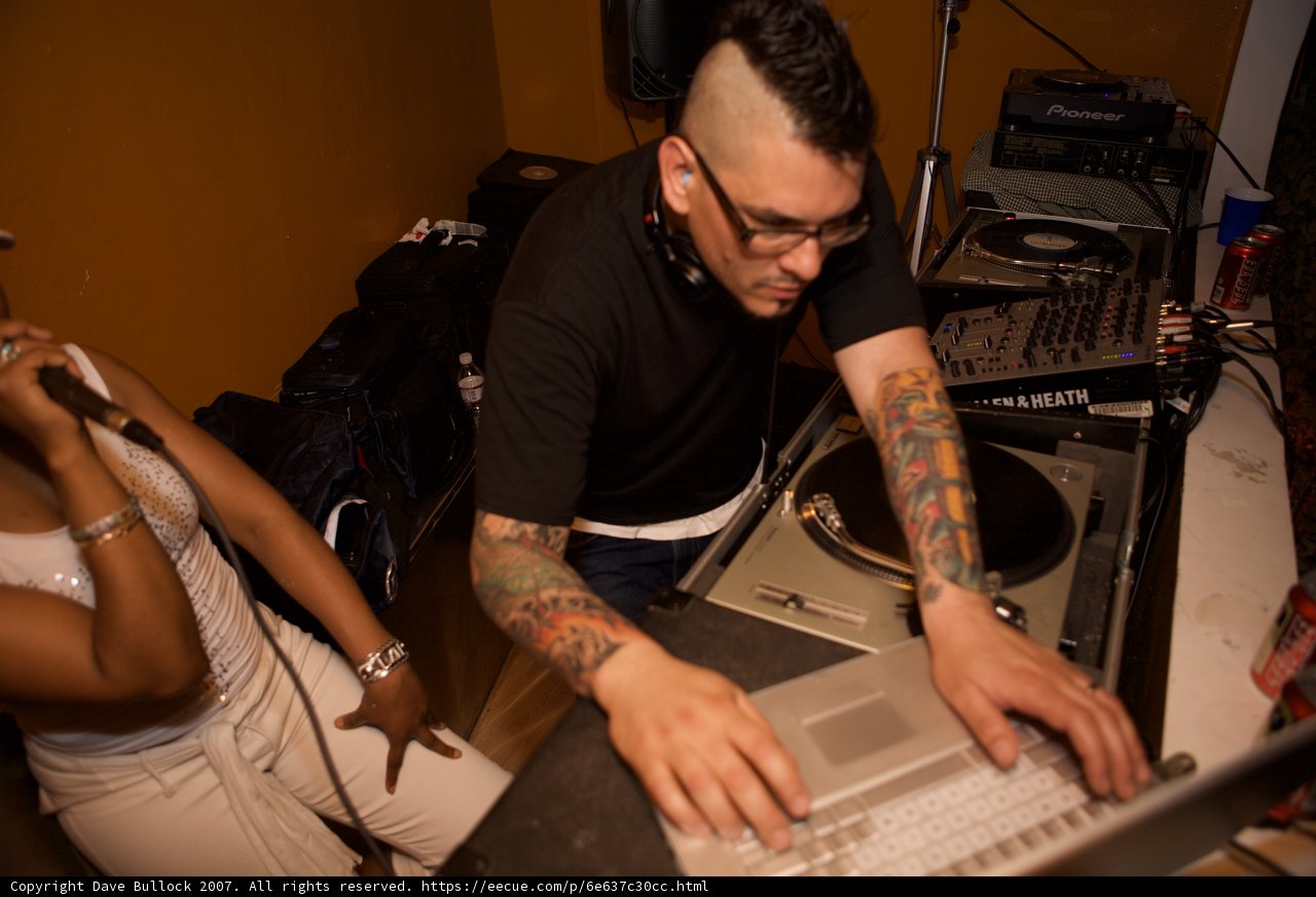 Dubstep DJ with Tattooed Arms Mixing Music