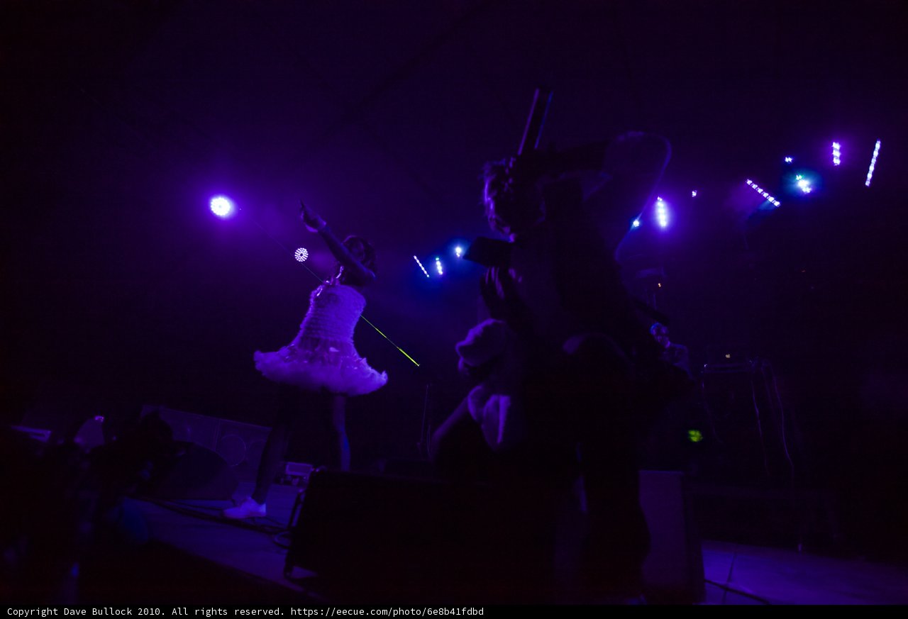 Purple Lights Spotlight on White Dress Singer