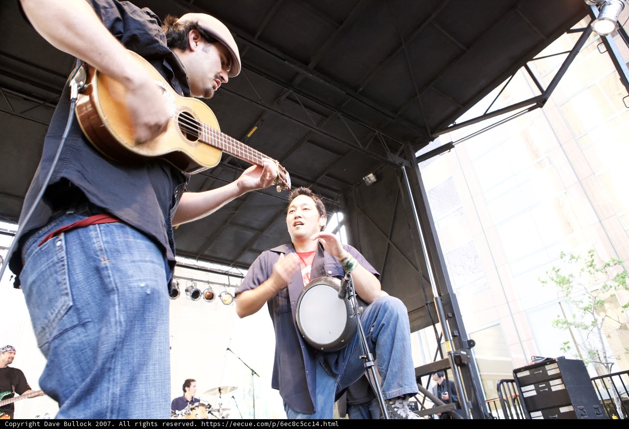 Jason Davis strums his guitar at the Grand Performances Ozomatli concert, 2007