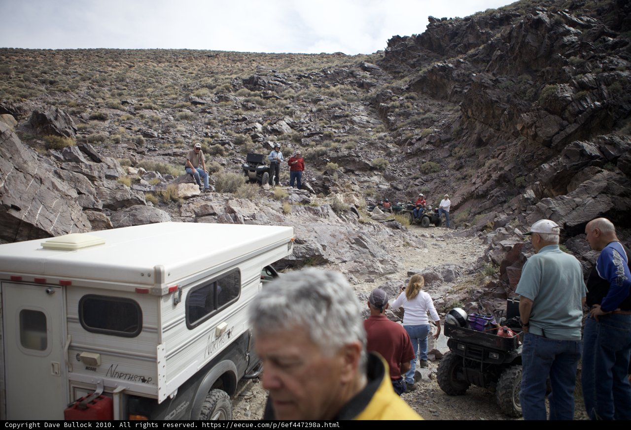 Desert Explorers Gather Around Their Mode of Transportation