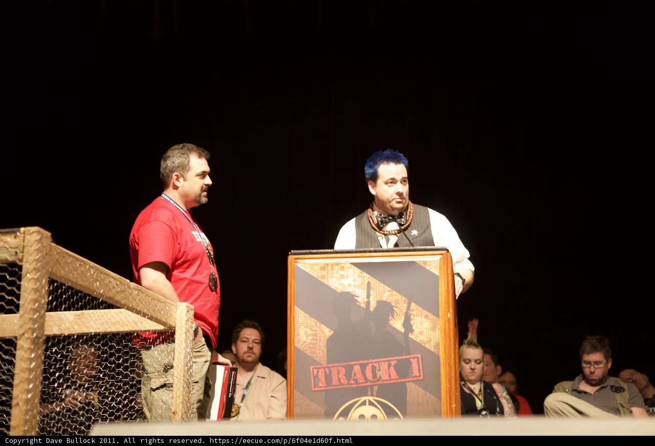Men at Podium Addressing Crowd with Microphone