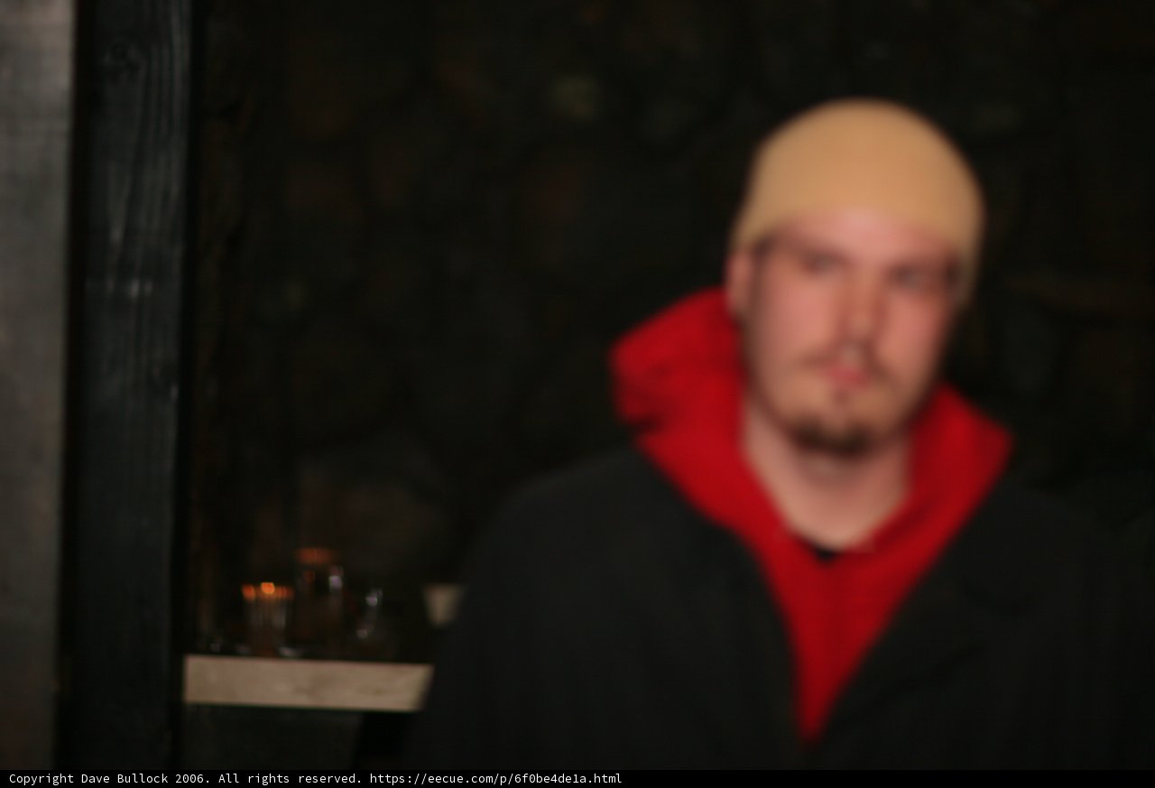 Blurry Snapshot of a Red Jacketed Man