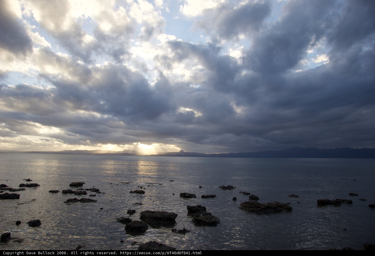 Moody Sky Over Rocky Waters