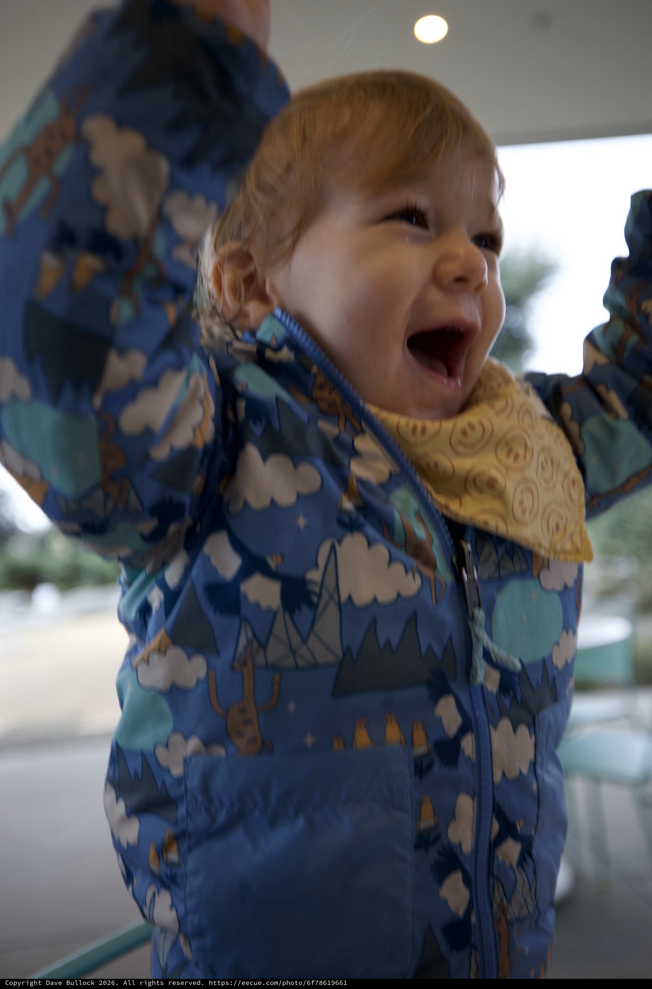 Joyful Toddler in Cloud-Pattern Winter Jacket