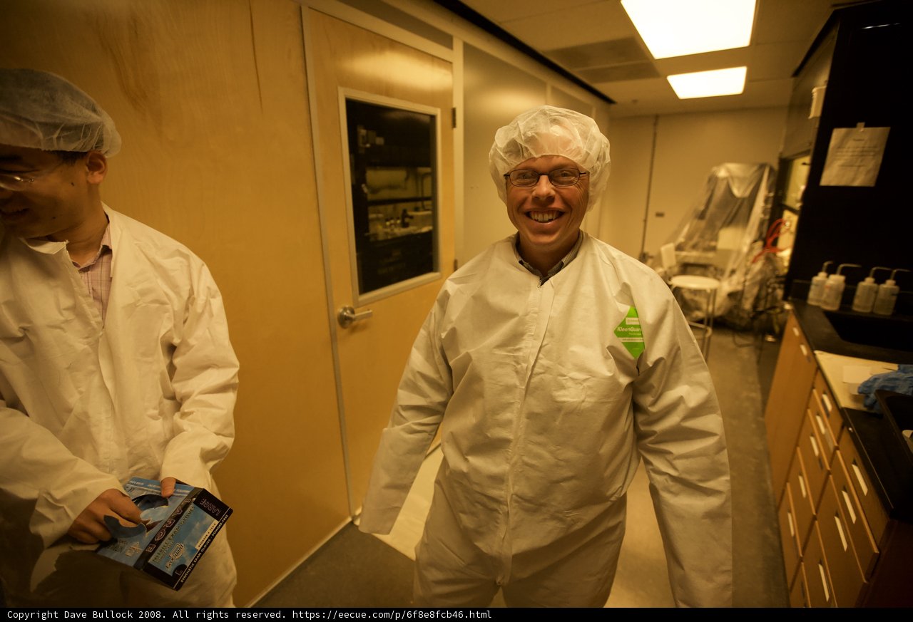 Lab Coated Men Examining Optical Equipment