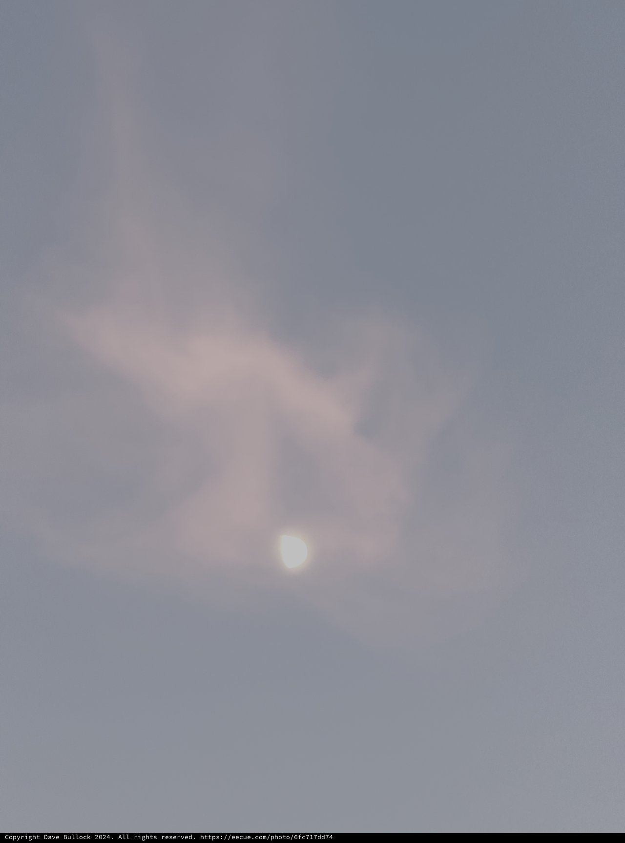 Ethereal Moon Through Misty Clouds at Dawn