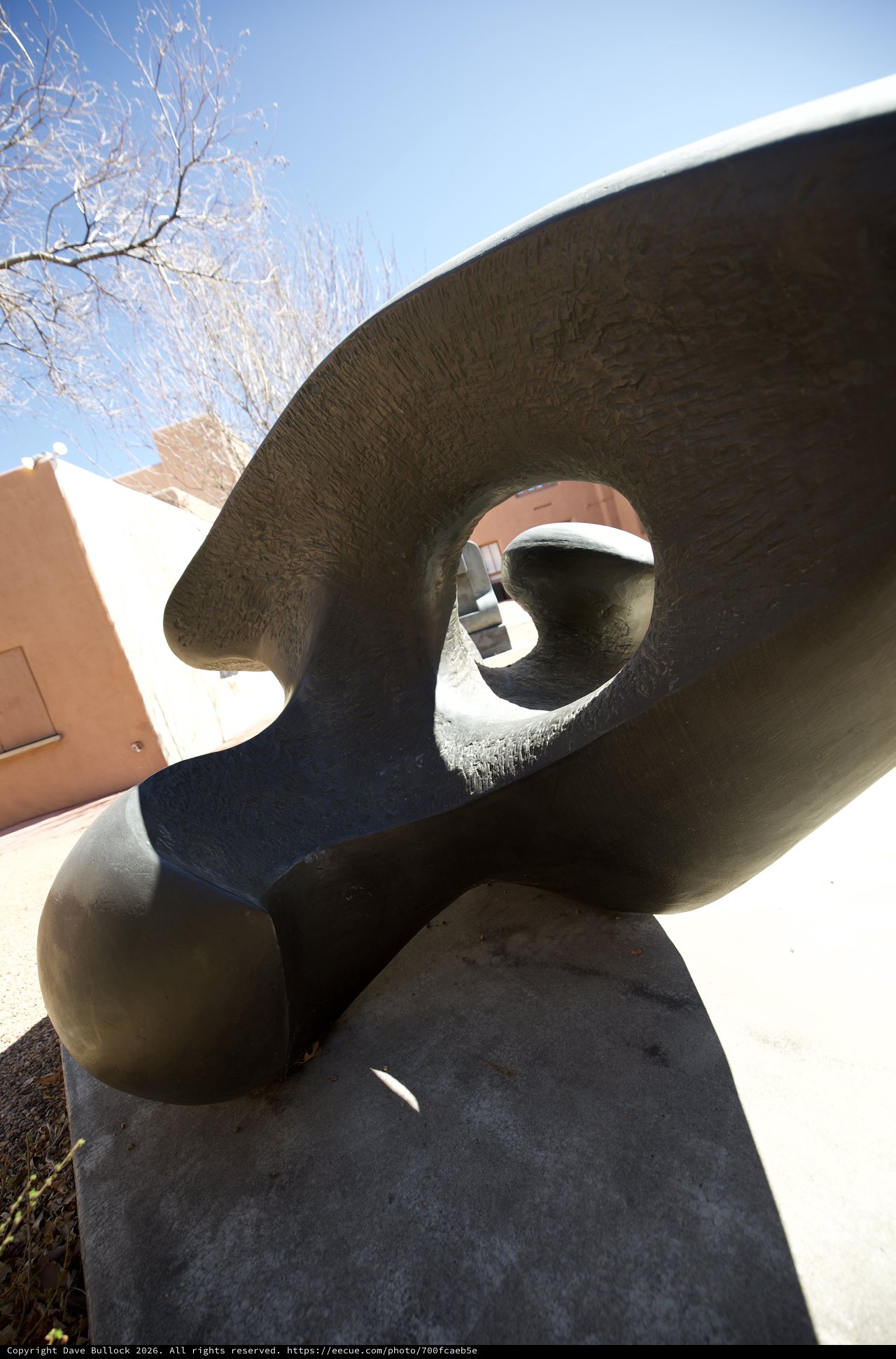 Abstract Bronze Sculpture with Circular Void in Winter Sunlight