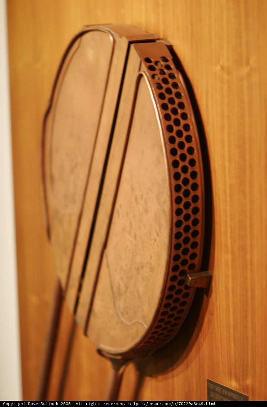 The Brown Metal Drum on the Wooden Wall