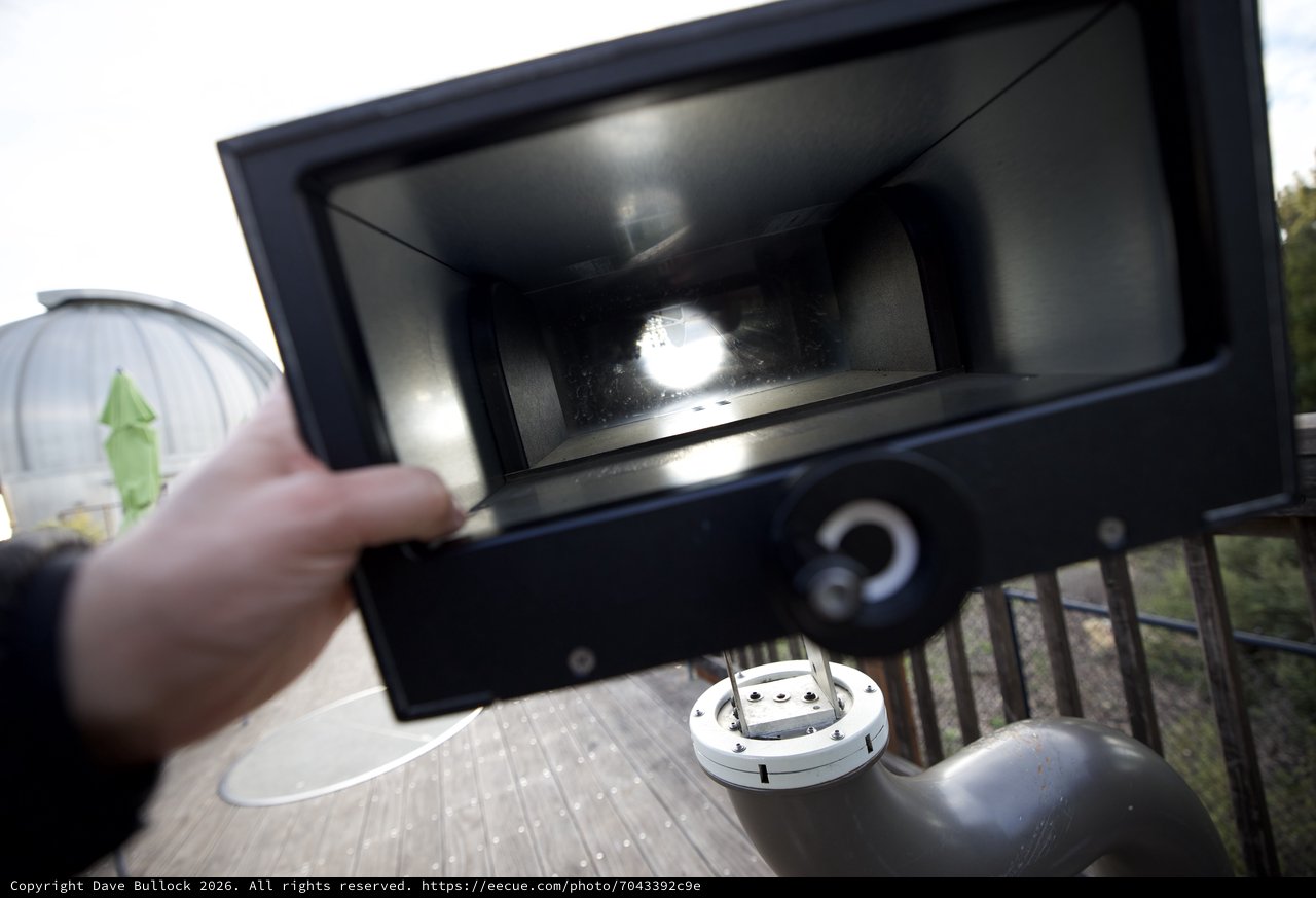 Opening the Grill Lid on an Outdoor Deck