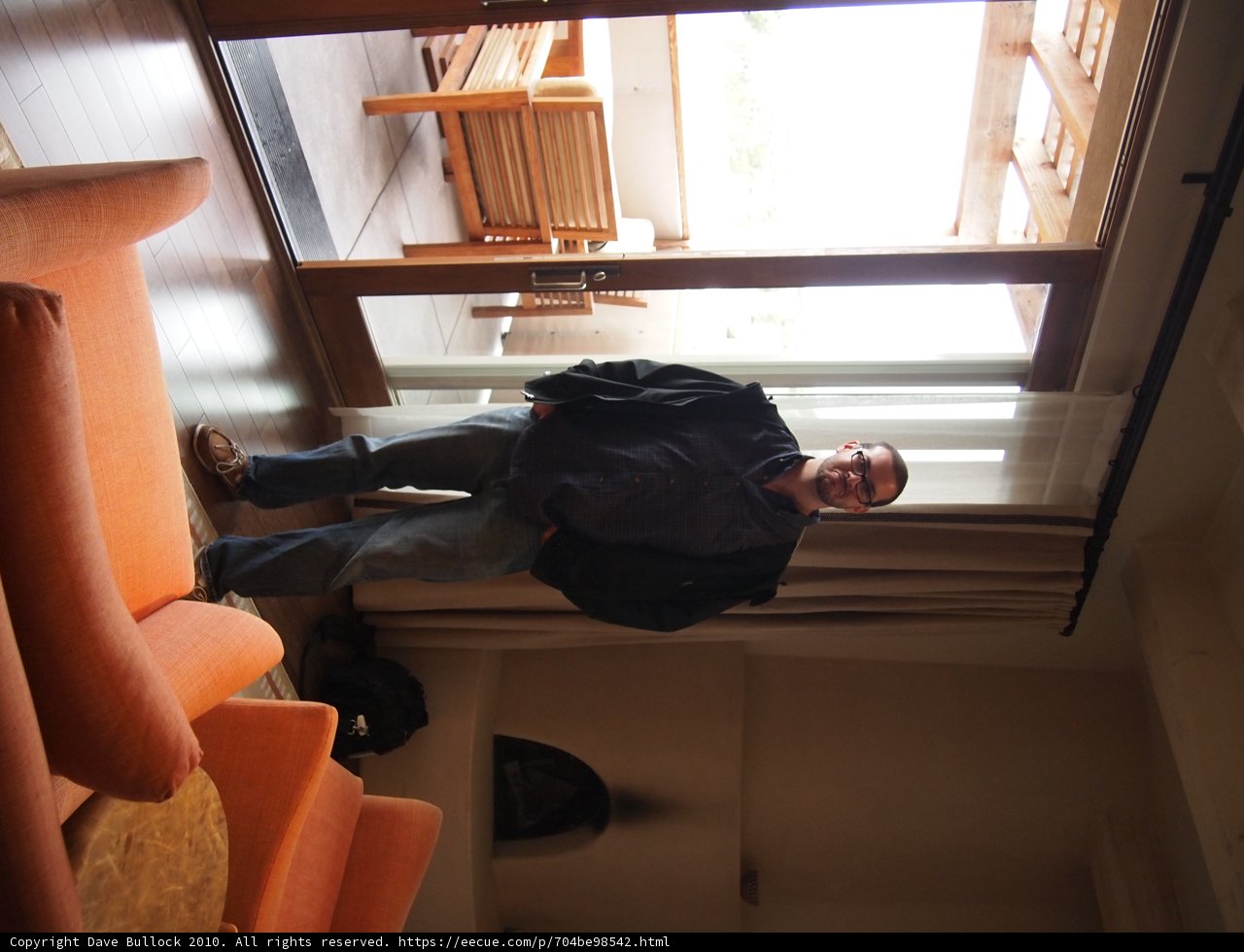 Man Looking Out Window in a Cozy Living Room
