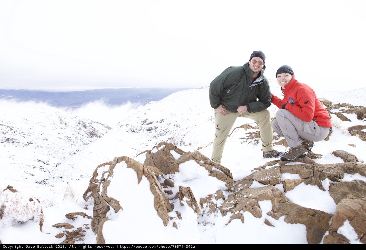 Two Hikers Celebrate Summit in Snowy Mountain Wilderness