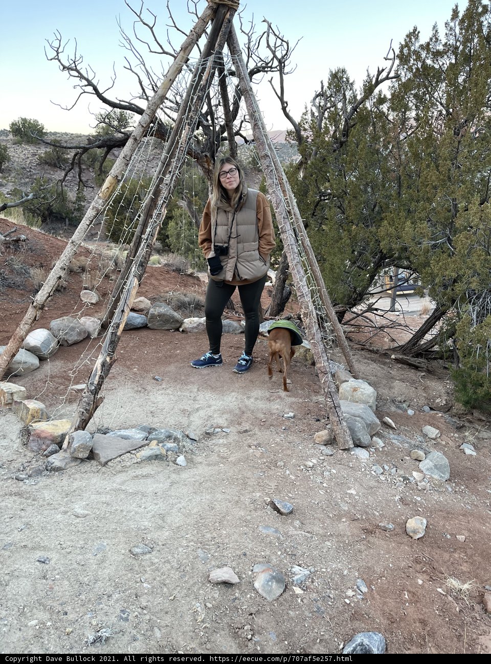 Woman and Dog next to Teepee in the Wilderness