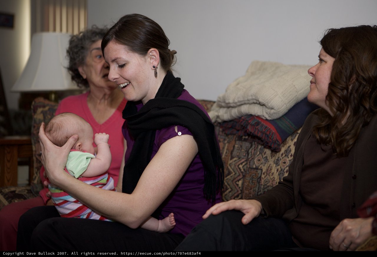 Three Generations Bonding Over a Newborn Baby