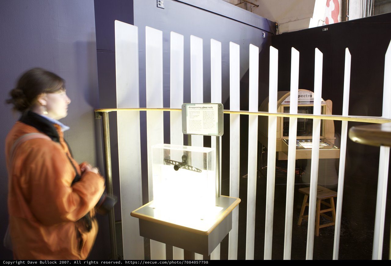 Museum Visitor Examines Disappearing Glass Rods Exhibit