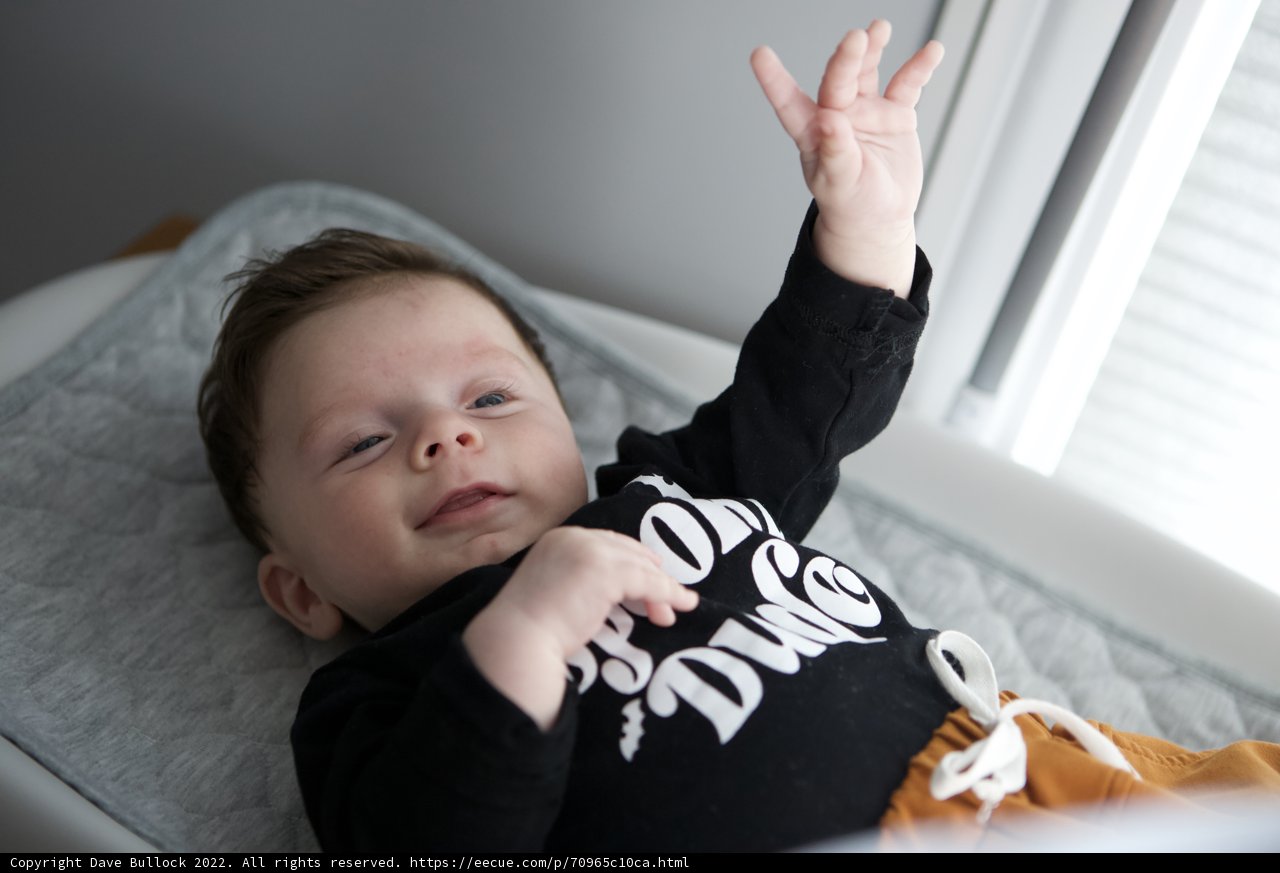 Sleepy Baby with Hands Raised