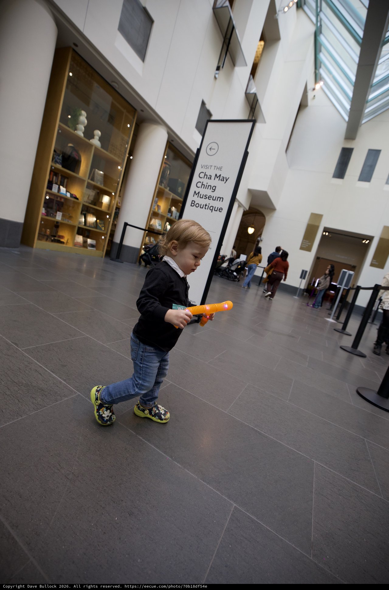 Young Child Exploring Asian Art Museum with Toy