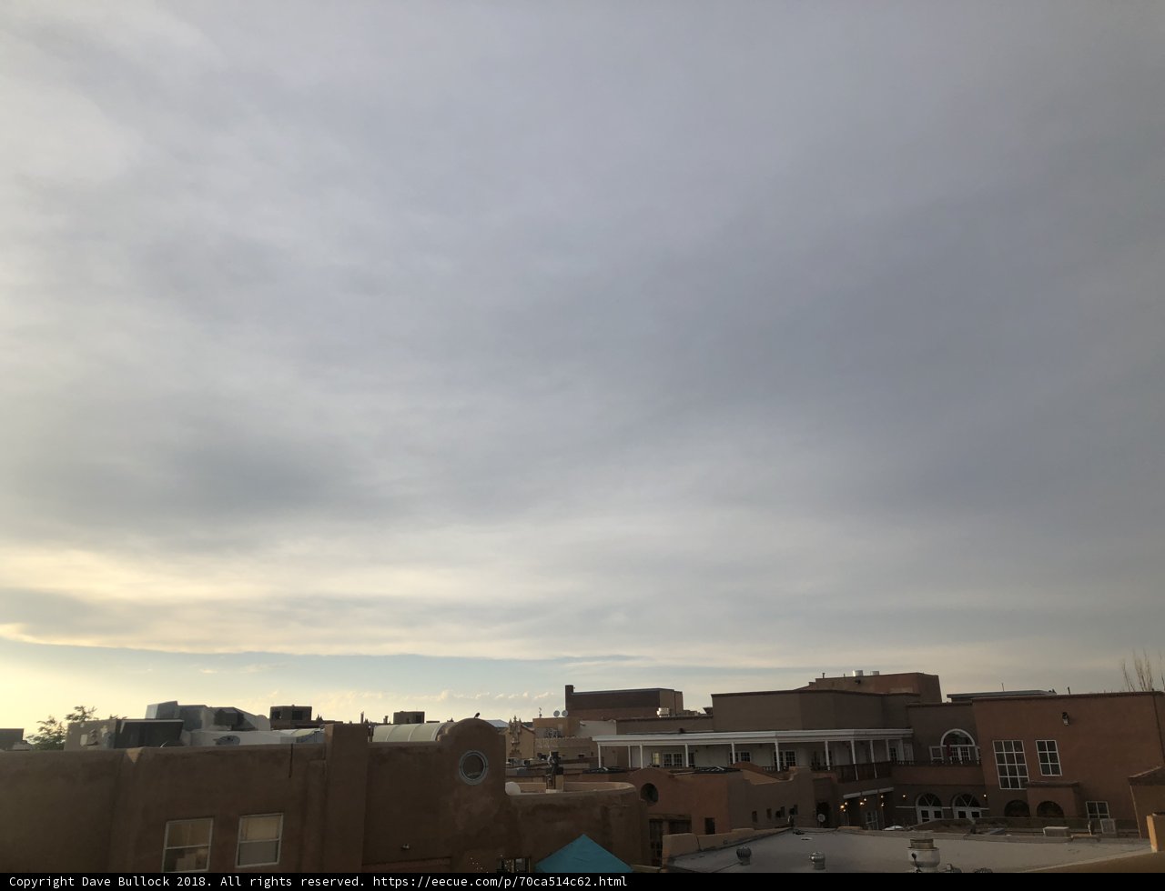 Kite Flying Over Urban Skyline