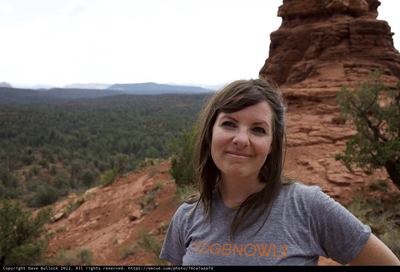 Woman Smiling Atop Red Rock Formation in Sedona