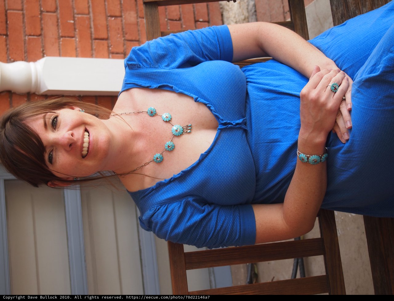 Smiling Woman in Blue Dress with Turquoise Jewelry