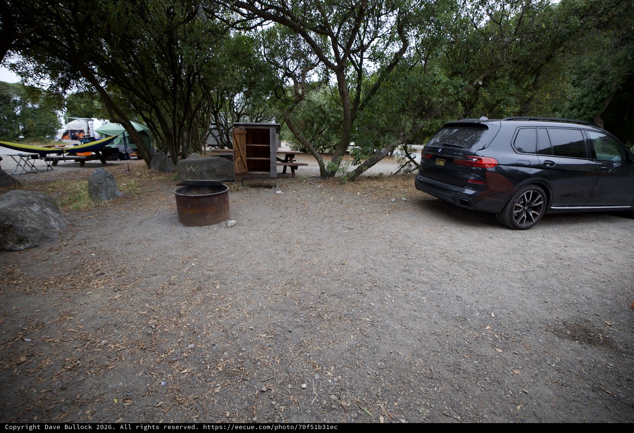 BMW SUV Parked at Shaded Campground Fire Pit